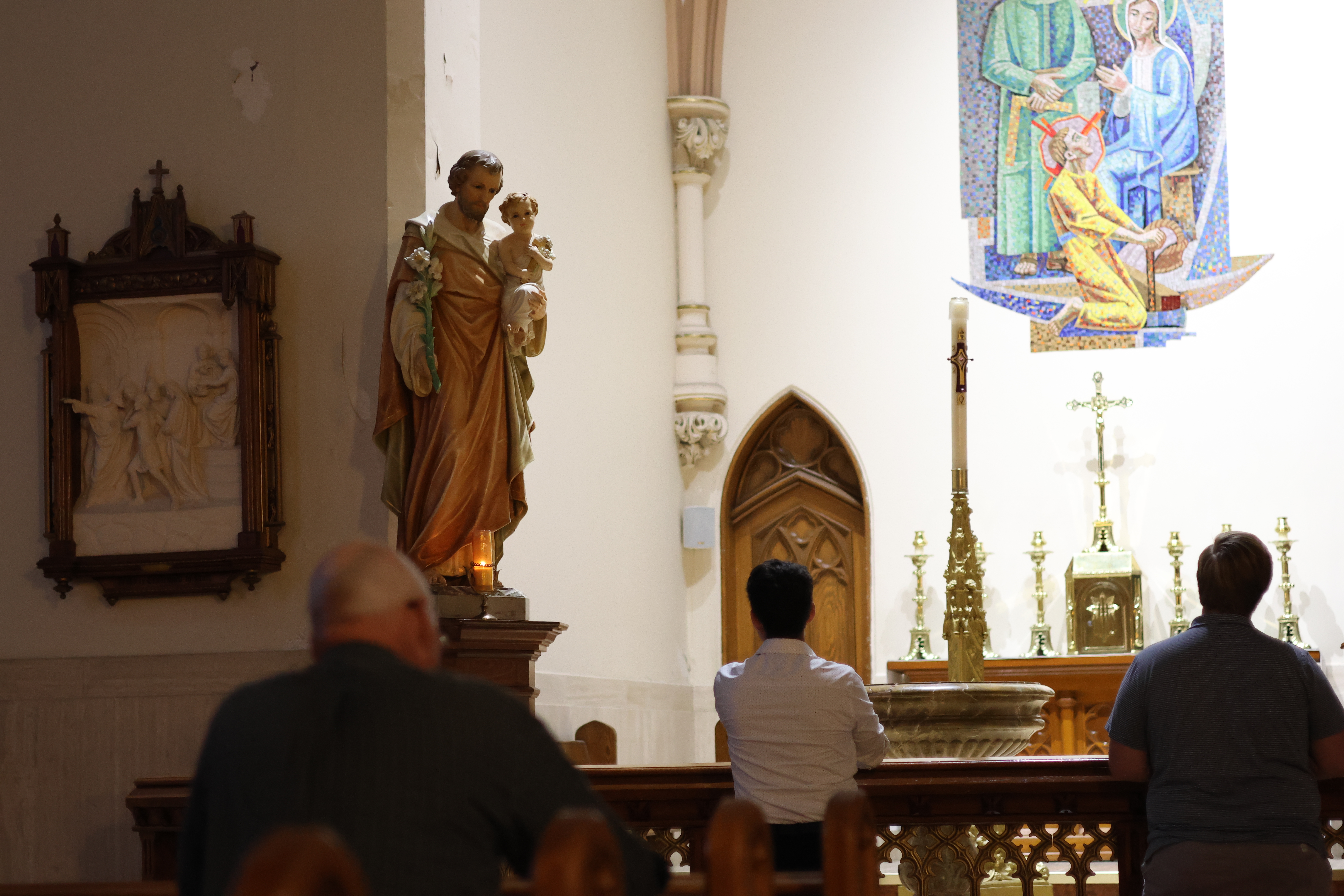 Photo of Catholic men, kneeling and praying the Rosary in front of the Saint Joseph chapel at the Cathedral of the immaculate conception