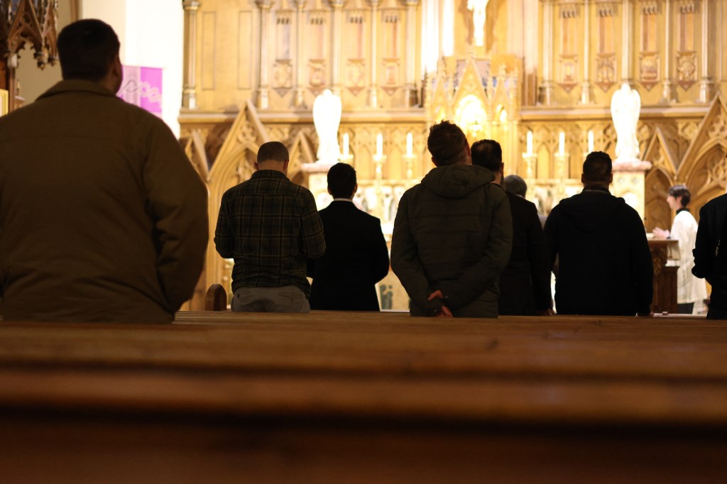 Men praying the rosary